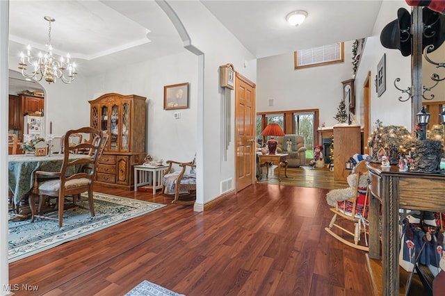 foyer entrance with a notable chandelier and dark wood-type flooring