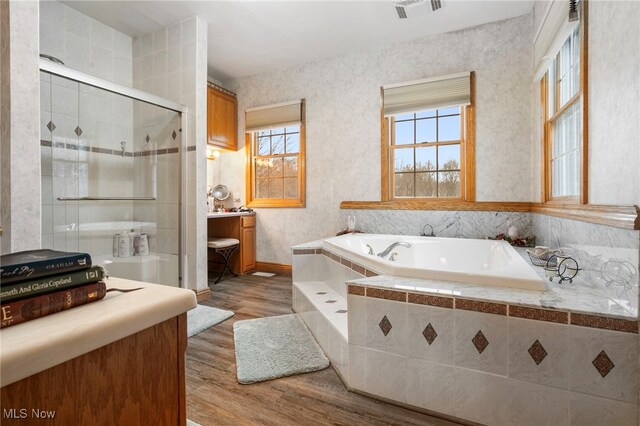 bathroom featuring hardwood / wood-style floors, vanity, and independent shower and bath