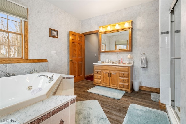 bathroom featuring hardwood / wood-style floors, vanity, and shower with separate bathtub