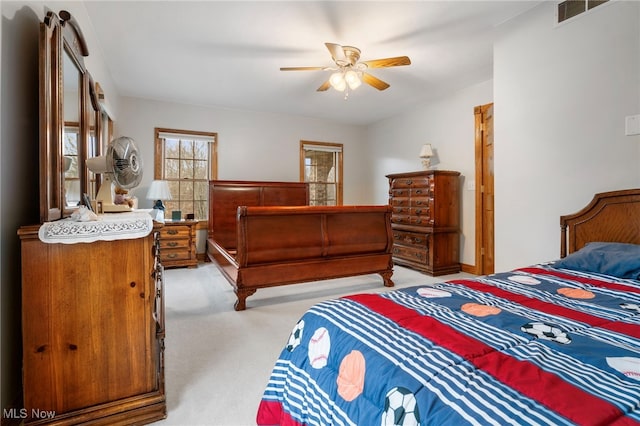 bedroom with light carpet and ceiling fan