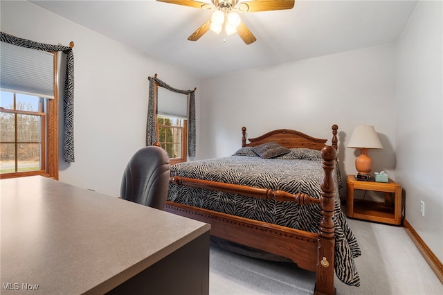 carpeted bedroom with ceiling fan, lofted ceiling, and multiple windows