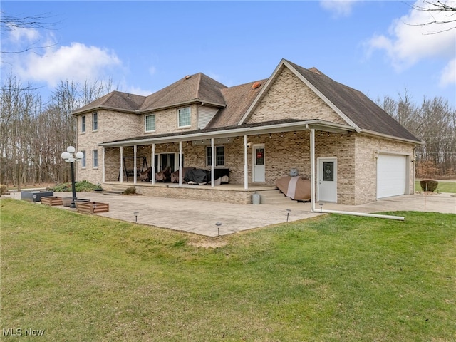 rear view of house featuring a yard, a porch, and a garage