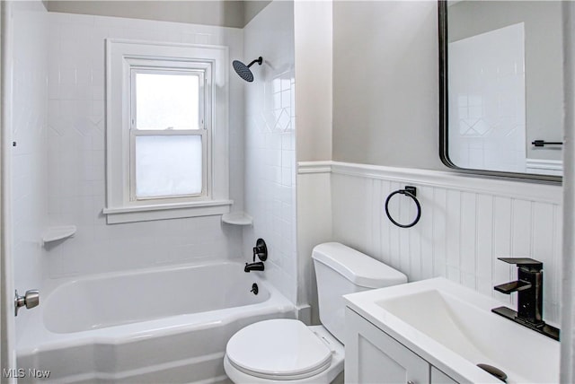 full bathroom with vanity, tiled shower / bath combo, and toilet