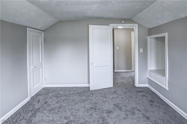 bonus room with a textured ceiling, carpet floors, and vaulted ceiling