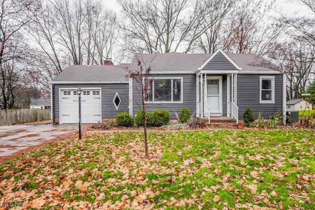 ranch-style home with a garage, a front yard, and central AC