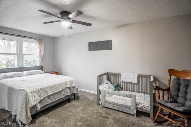 carpeted bedroom with a textured ceiling and ceiling fan