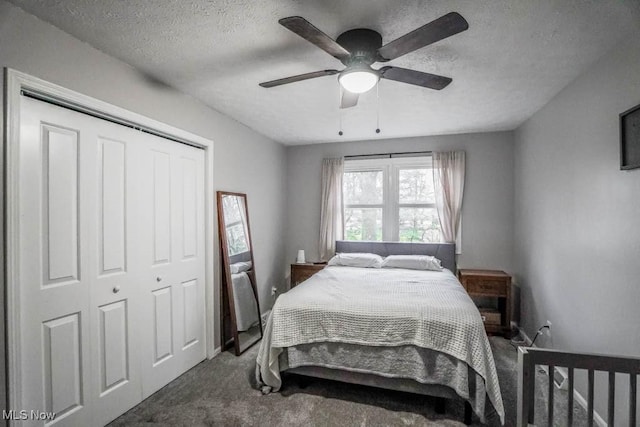 carpeted bedroom with a textured ceiling, a closet, and ceiling fan