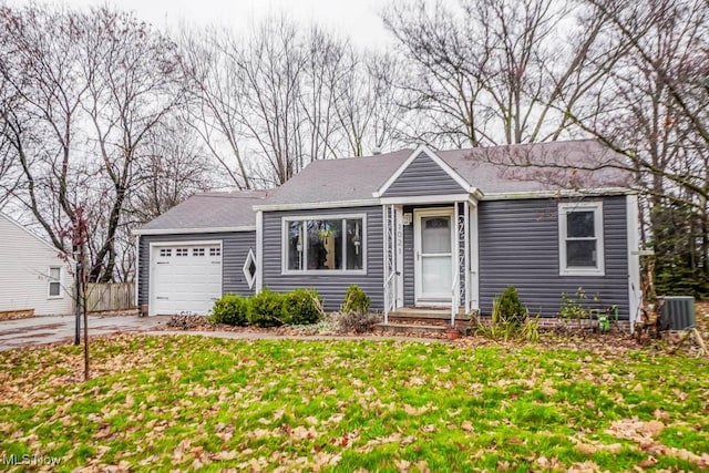 single story home featuring central AC, a front yard, and a garage