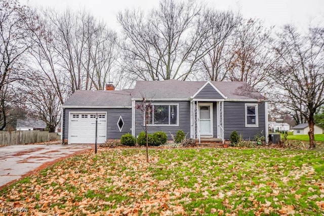 view of front of house featuring a garage and a front lawn