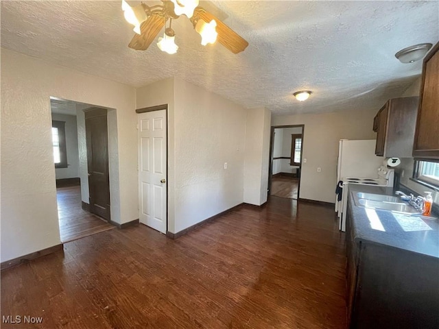 kitchen featuring a textured ceiling, ceiling fan, a healthy amount of sunlight, and dark hardwood / wood-style floors