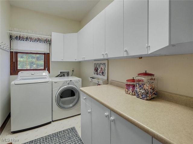 laundry area featuring cabinets and washing machine and clothes dryer