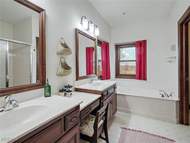 bathroom featuring vanity and independent shower and bath