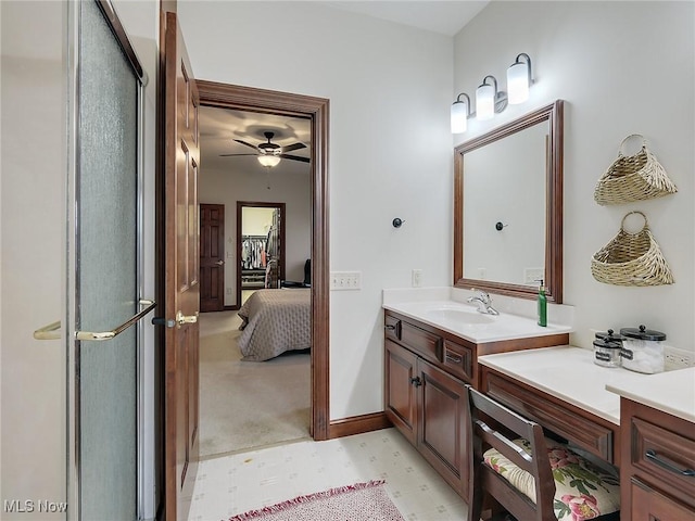 bathroom with vanity, ceiling fan, and a shower with door