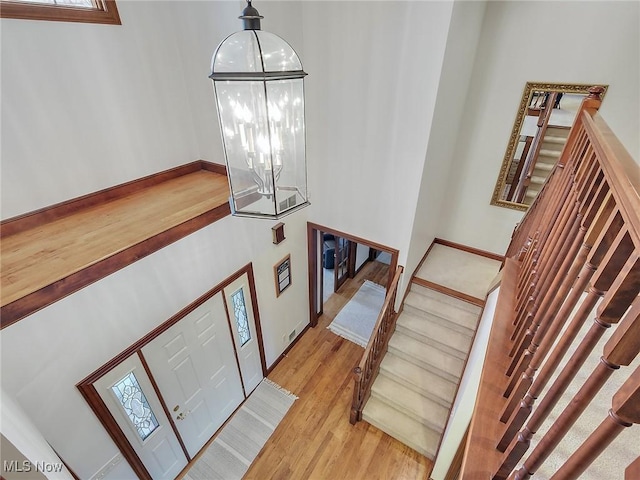 foyer featuring a notable chandelier and light hardwood / wood-style floors