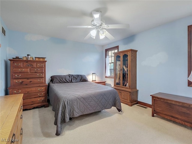 bedroom with ceiling fan and light carpet