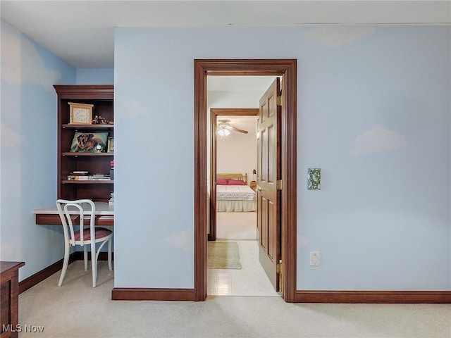 hallway featuring light carpet