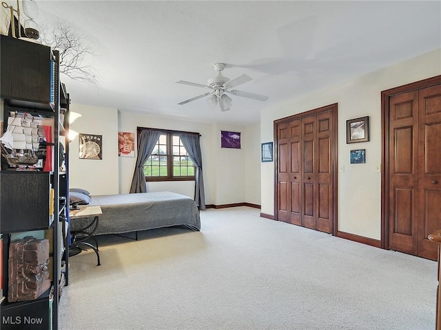 carpeted bedroom featuring ceiling fan and a closet