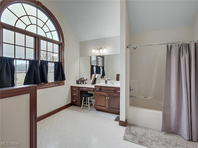 bathroom with vanity, shower / bathtub combination with curtain, and vaulted ceiling