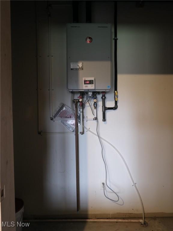 utility room with tankless water heater