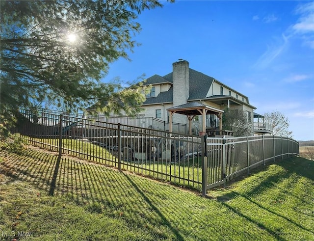 exterior space with a gazebo and a lawn