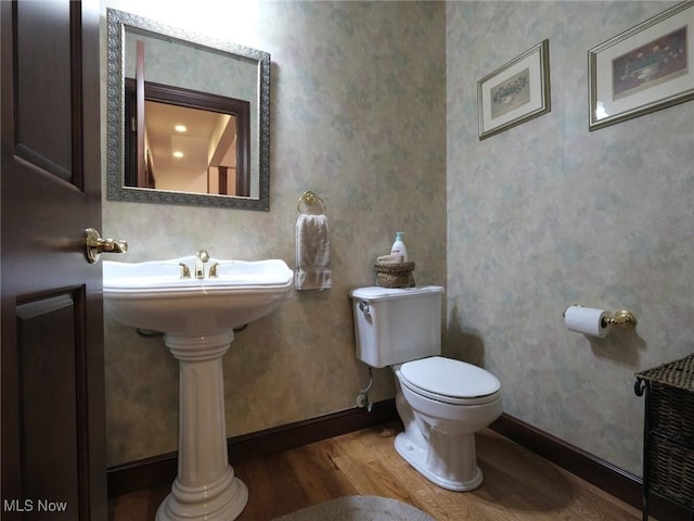 bathroom featuring hardwood / wood-style floors and toilet