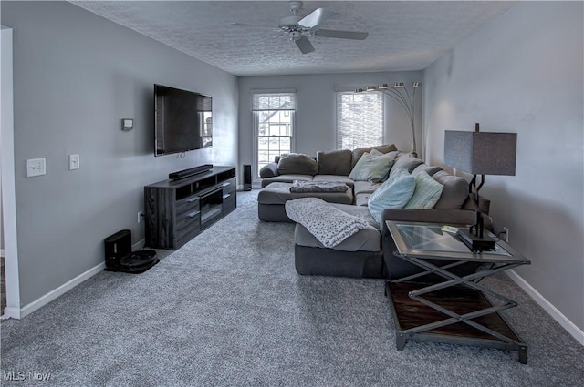 carpeted living room featuring a textured ceiling and ceiling fan