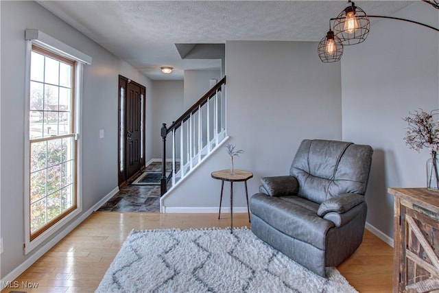 entryway with hardwood / wood-style floors and a textured ceiling