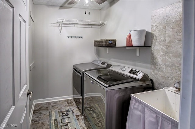 laundry area featuring ceiling fan, sink, and washing machine and clothes dryer