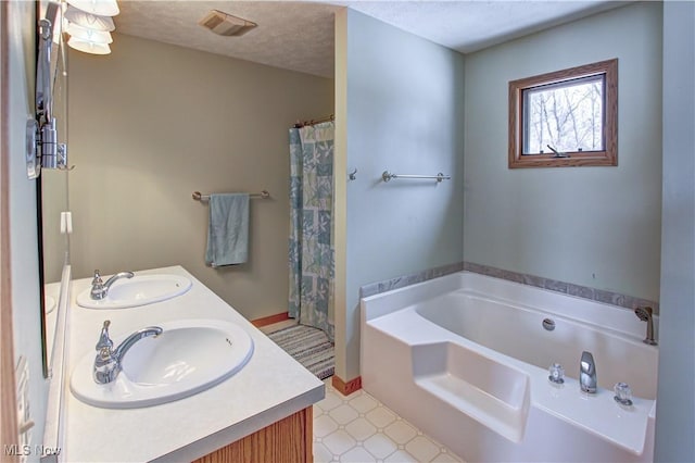 bathroom featuring plus walk in shower, vanity, and a textured ceiling