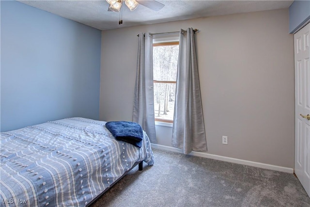 carpeted bedroom featuring a textured ceiling and ceiling fan