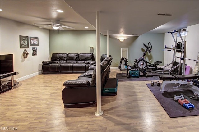 living room featuring light hardwood / wood-style flooring and ceiling fan