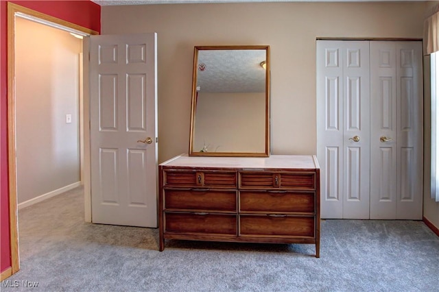 carpeted bedroom featuring a textured ceiling