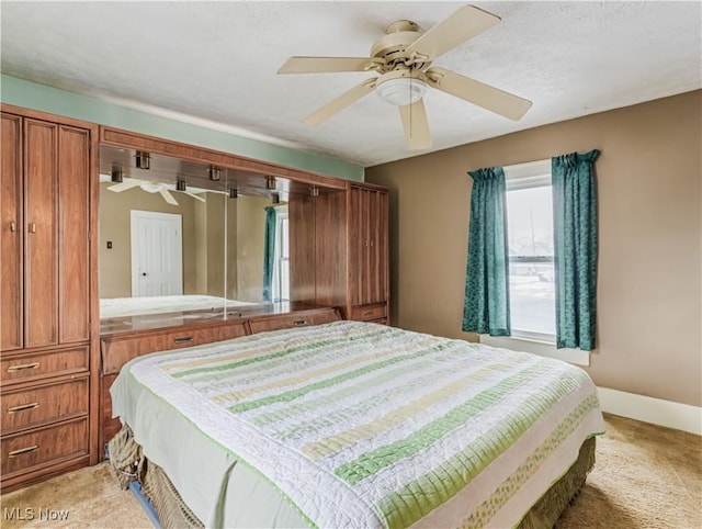 bedroom with light colored carpet and ceiling fan