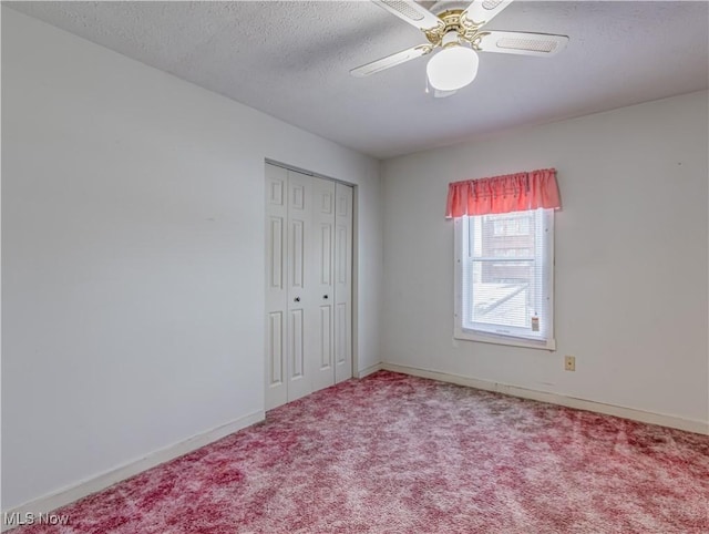 unfurnished bedroom with carpet, a textured ceiling, a closet, and ceiling fan