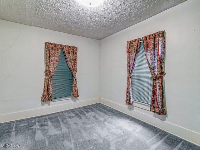 empty room featuring carpet flooring and a textured ceiling