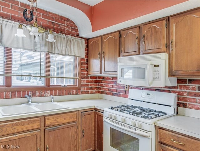 kitchen with sink and white appliances