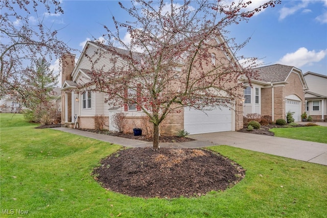 view of front of property featuring a front yard and a garage