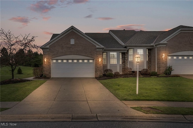 view of front of property with a yard and a garage