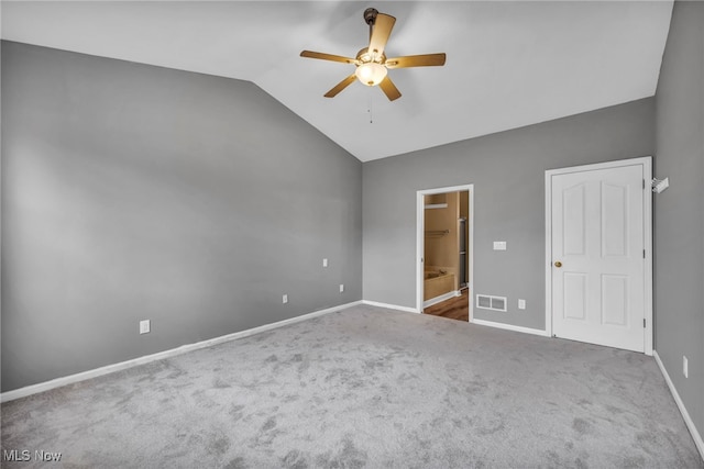 unfurnished bedroom with carpet floors, ensuite bathroom, ceiling fan, and lofted ceiling