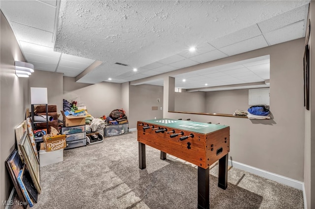 game room featuring carpet flooring and a paneled ceiling