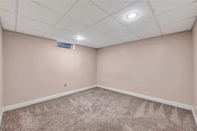 basement with a drop ceiling and carpet