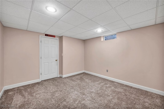 basement featuring carpet flooring and a drop ceiling