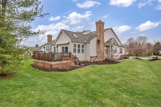 rear view of property with a lawn and a wooden deck