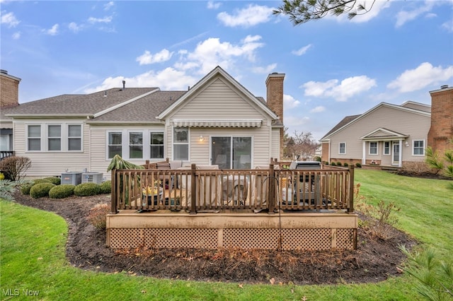 back of house with a lawn, a wooden deck, and central AC unit