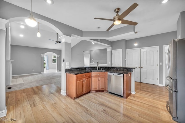 kitchen featuring stainless steel appliances, light hardwood / wood-style flooring, hanging light fixtures, and ceiling fan