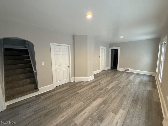 unfurnished living room featuring dark hardwood / wood-style flooring