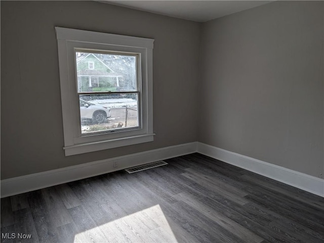 empty room with hardwood / wood-style flooring