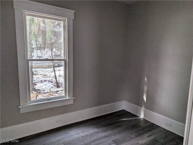 spare room featuring dark wood-type flooring