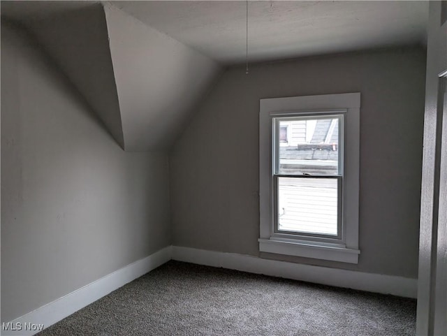 bonus room featuring carpet flooring and lofted ceiling