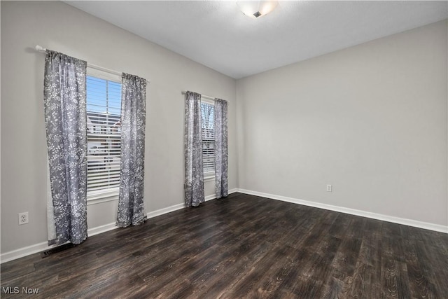 unfurnished room with dark wood-type flooring and a healthy amount of sunlight